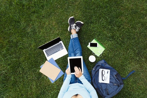 student working on computer on campus