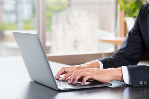 man working at computer on desk
