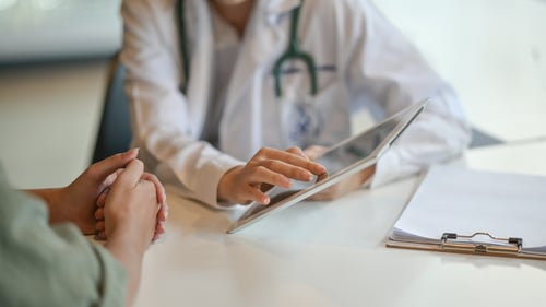 doctors reviewing data on tablet in medical practice office