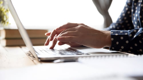 woman typing on laptop