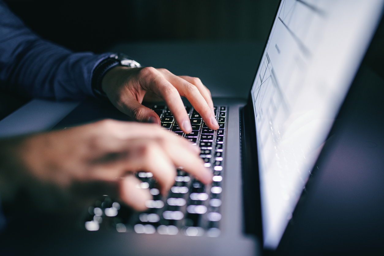 close up of laptop and employee